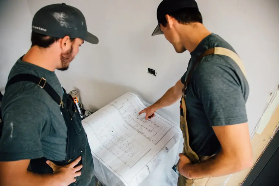 RooHam electricians reviewing electrical plans on site